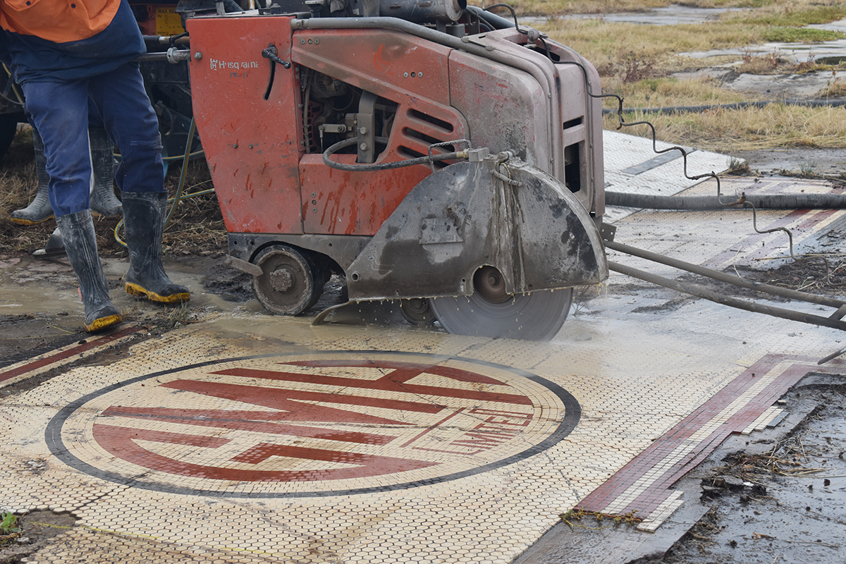 Photo of cutting GM Holden mosaic with road saw.