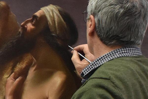 Conservator infilling painting