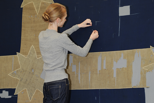 Conservator hand stitching Eureka flag