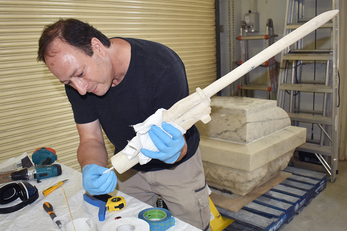 Conservator fixing part of monument