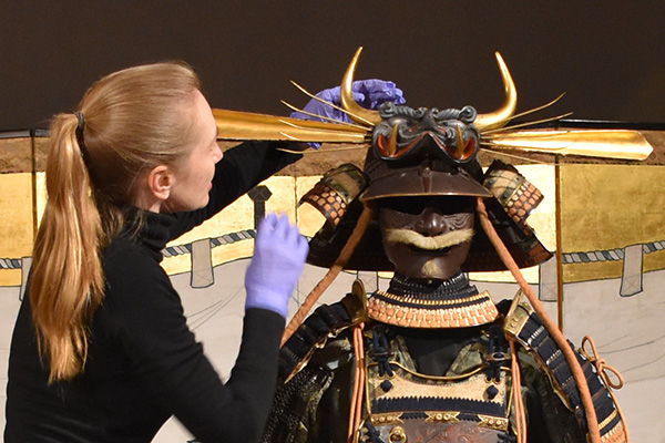 Conservators installing Samurai armour