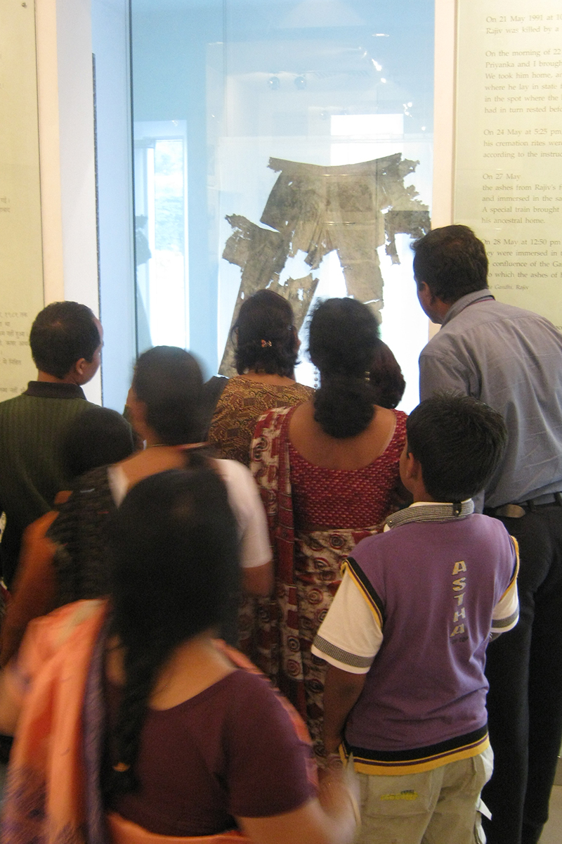 People looking at trousers on display