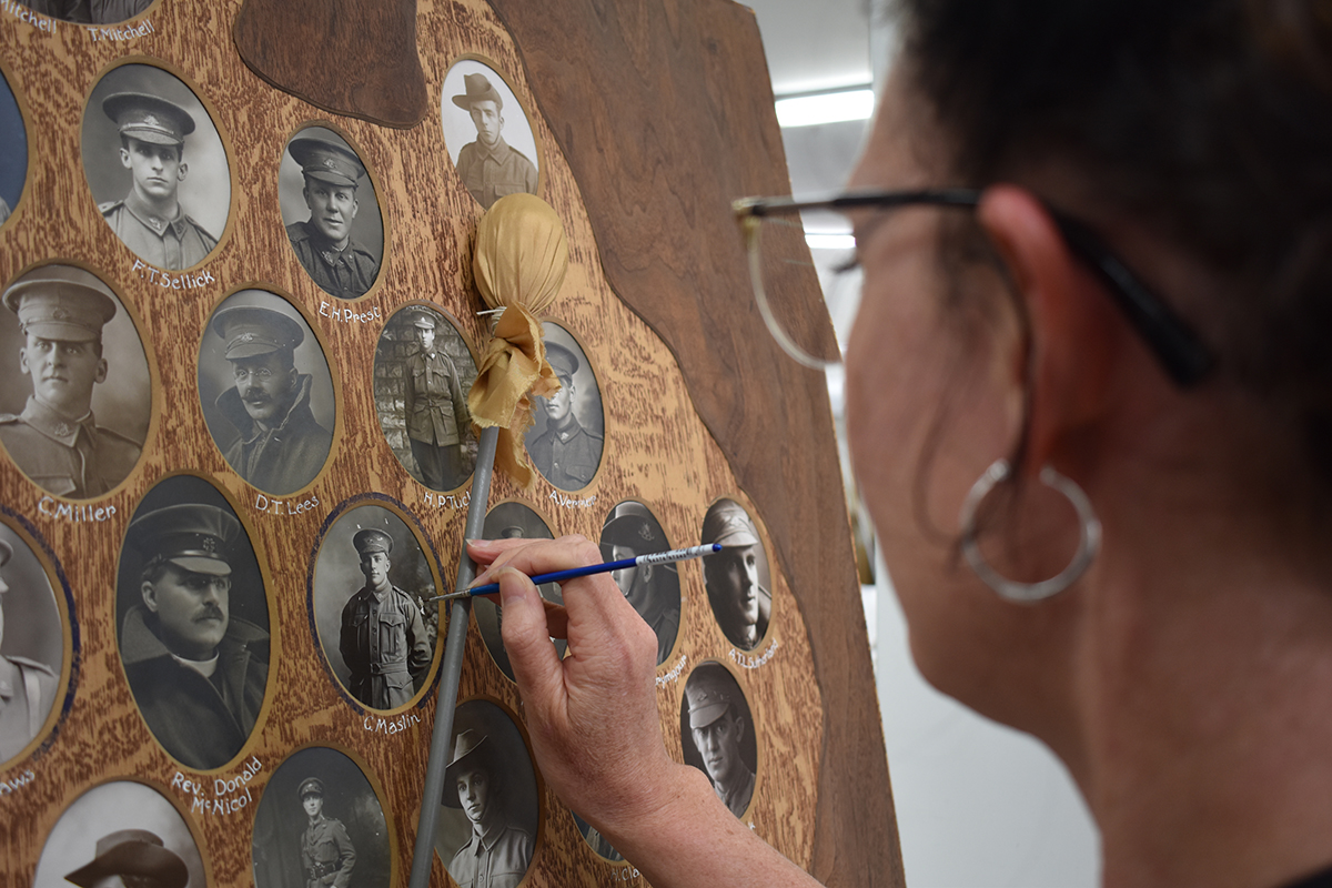 Conservator working on WW1 Honour Board