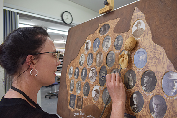 Conservator working on WW1 Honour Board
