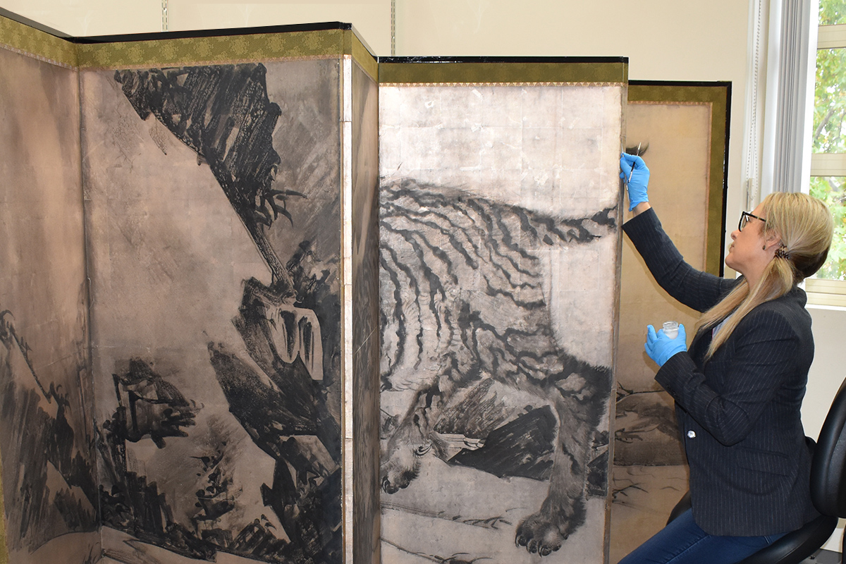 Paper conservator working on Japanese screen