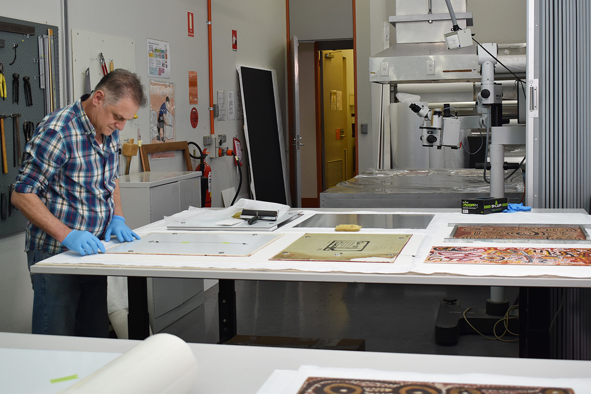 Conservator preparing back of painting