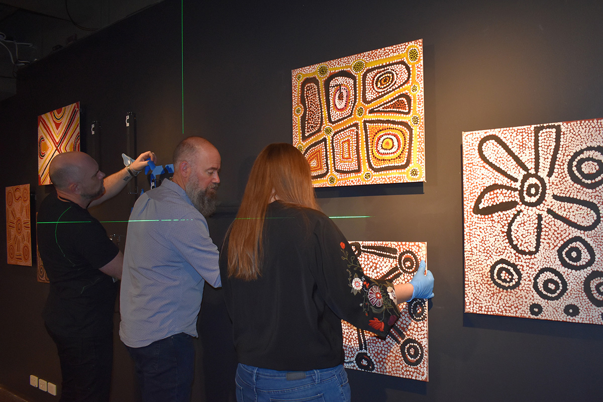 Museum staff installing Balgo paintings