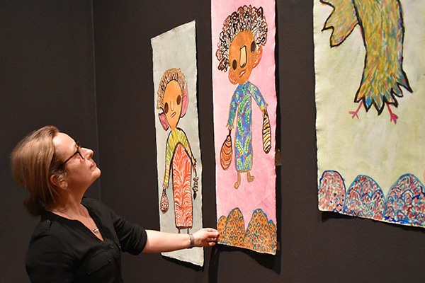 Conservator installing Tarnanthi 2020 artworks