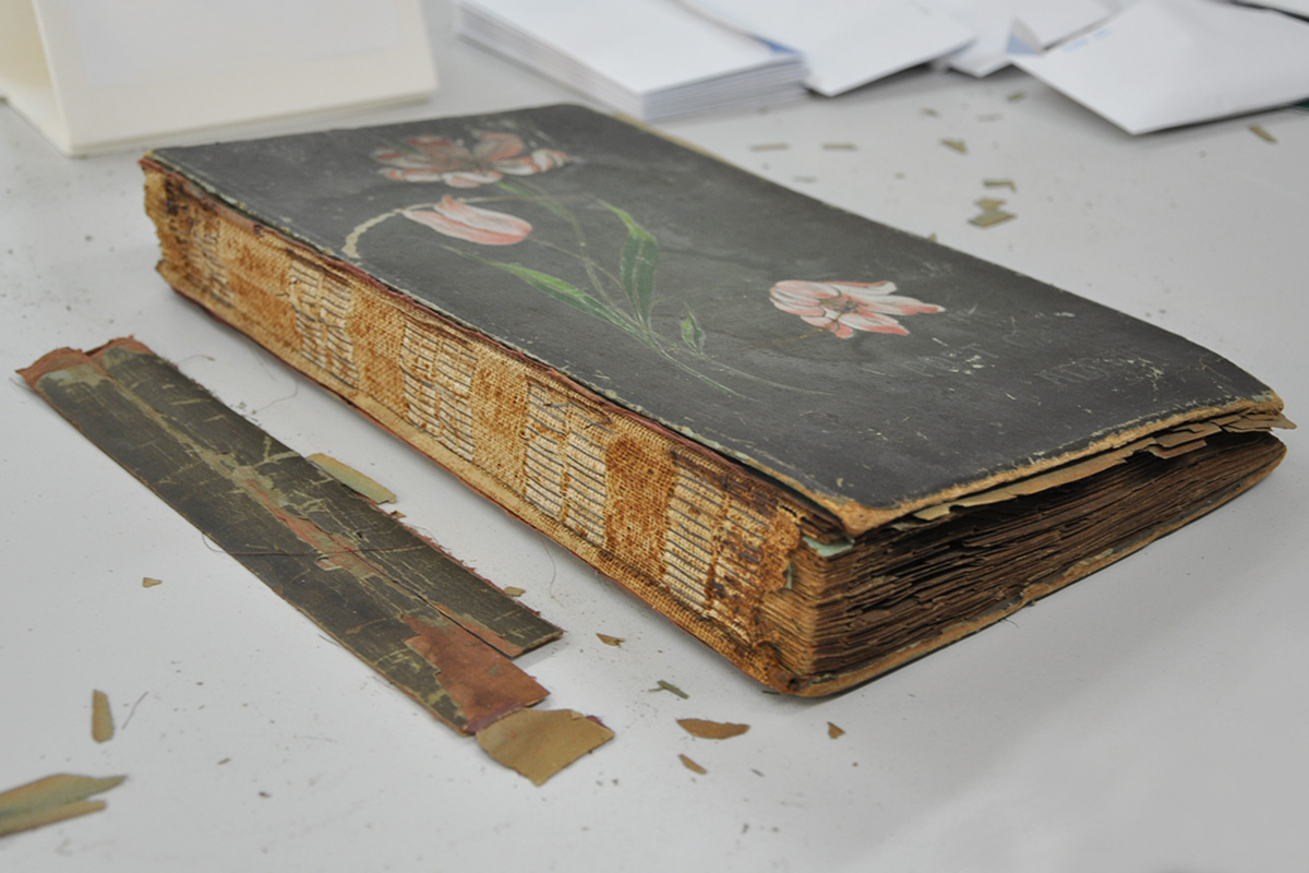 Damaged binding on postcard album
