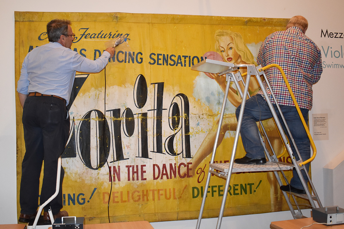 Conservators working on banner