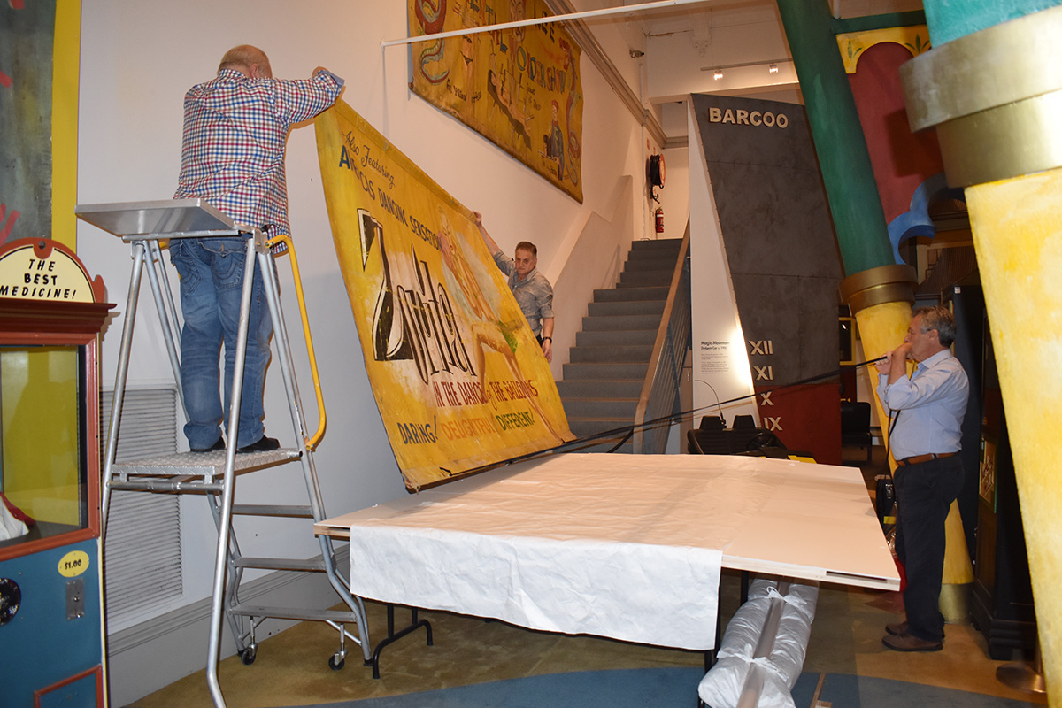 Conservators working on banner
