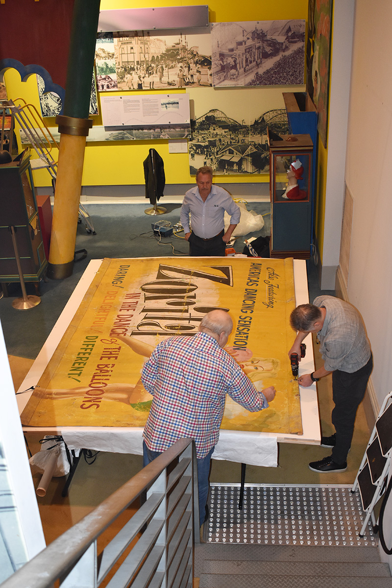 Conservators working on banner