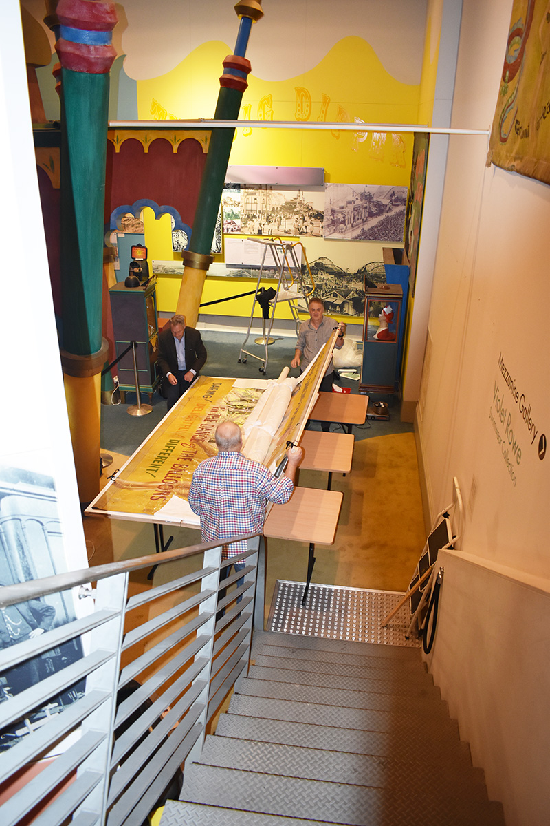 Conservators working on banner