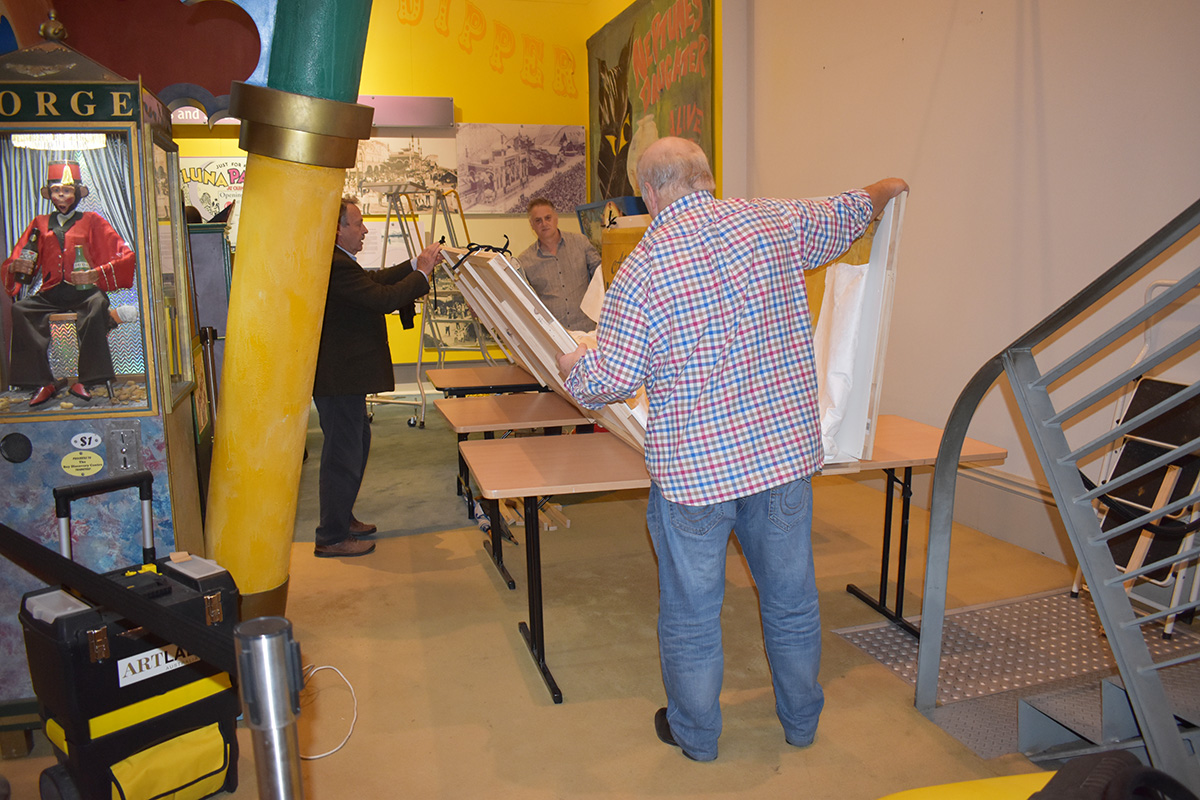 Conservators working on banner