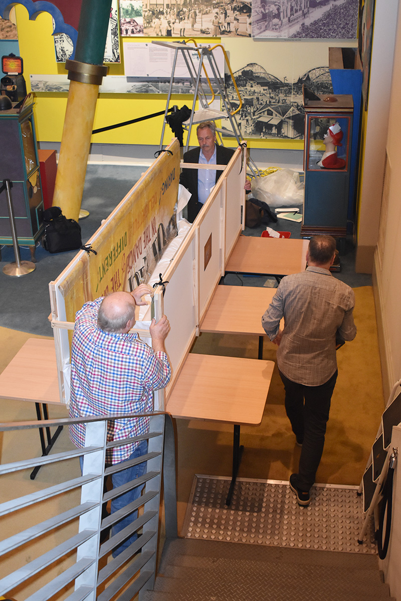 Conservators working on banner